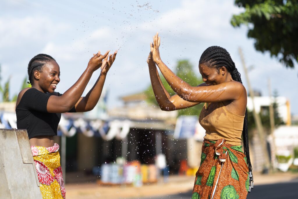 Synonyms for born and raised: young African women happily playing with each other